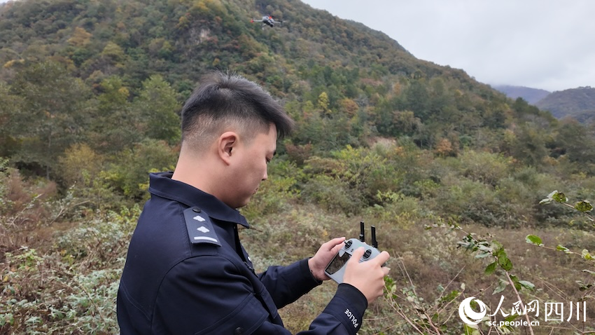 陈冠宇在坡地边使用无人机。人民网赵祖乐摄